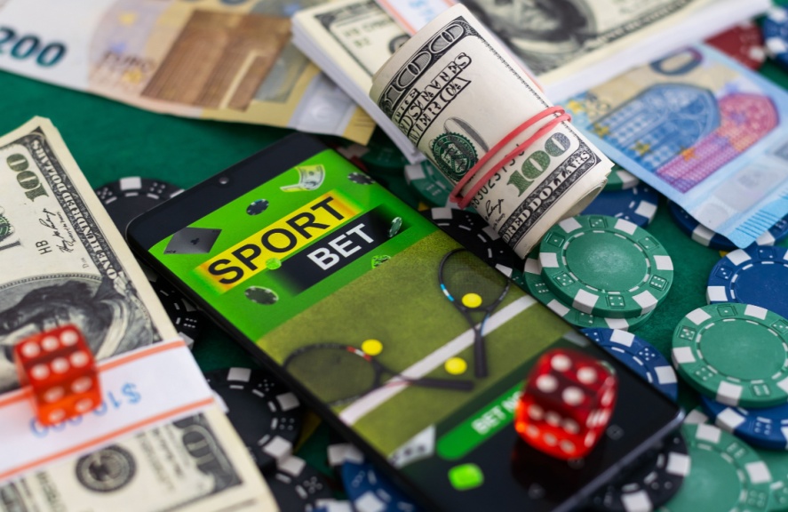 a betting site on a phone among cash and casino chips