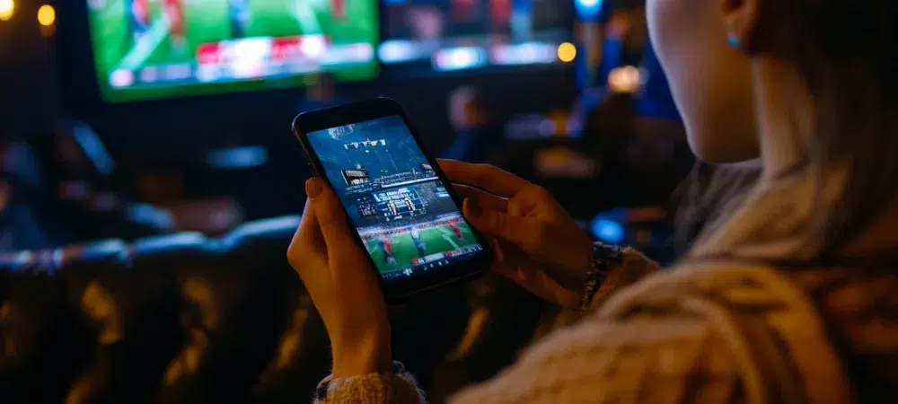 a person betting on sports with a phone